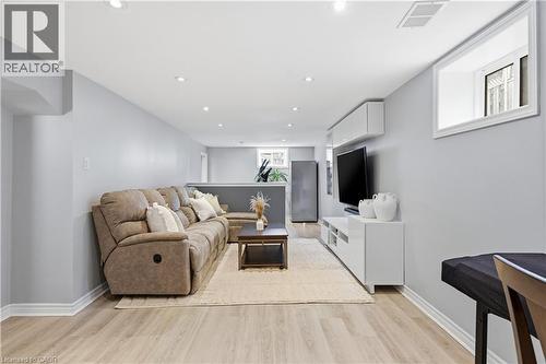 Finished entertainment space featuring light wood-finish flooring and recessed lighting - 189 Foxbar Road, Burlington, ON 