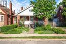 Brick and white siding exterior with a covered front porch featuring white railings - 295 Keswick Court, Hamilton, ON 