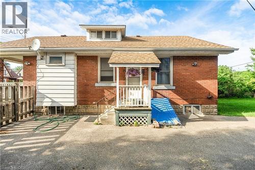 Red brick exterior with white siding accents and a dormer window - 295 Keswick Court, Hamilton, ON 