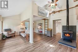 TWO LIVING AREAS WITH WOODSTOVE AND LADDER TO LOFT - 