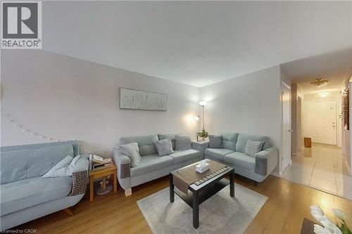 Living area with light-toned walls and wood-finish flooring - 233 Benesfort Crescent, Kitchener, ON 