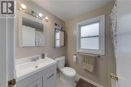 Bathroom featuring a vanity with an integrated sink, dual-door cabinetry, and a chrome faucet - 233 Benesfort Crescent, Kitchener, ON 
