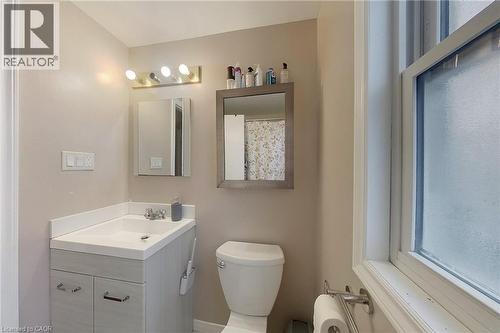 Bathroom featuring a single vanity with light-toned cabinetry, a white countertop, and a built-in sink - 233 Benesfort Crescent, Kitchener, ON 