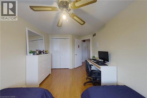 Neutral wall paint and wood-finish flooring define this interior space - 233 Benesfort Crescent, Kitchener, ON 