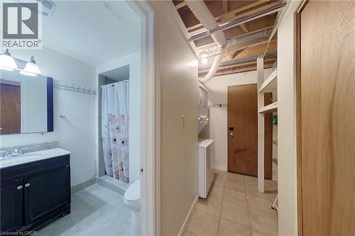 Bathroom featuring a dark wood-finish vanity with a light countertop and a shower stall - 233 Benesfort Crescent, Kitchener, ON 