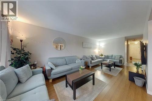 Open concept living area featuring wood-finish flooring and light-toned walls - 233 Benesfort Crescent, Kitchener, ON 