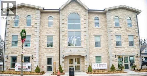 Three-story commercial building featuring a stone block exterior facade - 385 E Wilson Street E Unit# 201, Ancaster, ON 