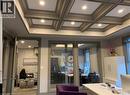 Coffered ceiling with integrated recessed lighting, glass-paneled doors, neutral wall tones, and crown molding - 385 E Wilson Street E Unit# 201, Ancaster, ON 