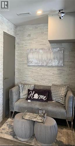 Textured accent wall with a horizontal stacked stone pattern - 385 E Wilson Street E Unit# 201, Ancaster, ON 