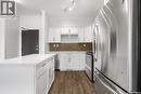 104 545 Hassard Close, Saskatoon, SK  - Indoor Photo Showing Kitchen With Stainless Steel Kitchen With Upgraded Kitchen 