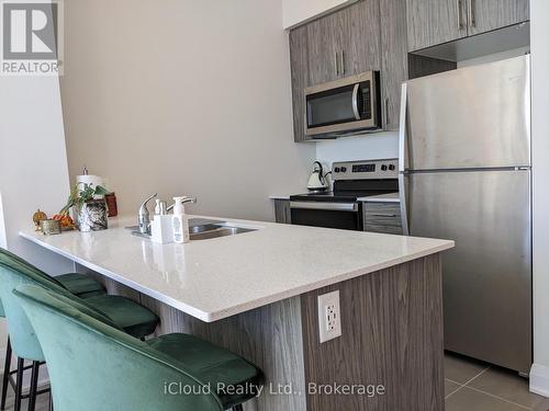Quartz Stone Breakfast Counter - 617 - 16 Concord Place, Grimsby, ON - Indoor Photo Showing Kitchen With Stainless Steel Kitchen With Double Sink