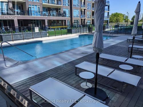 Poolside Lounge Area - 617 - 16 Concord Place, Grimsby, ON - Outdoor With In Ground Pool With Balcony
