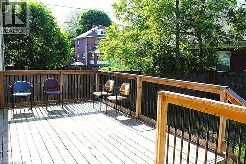 Outdoor wooden deck with plank flooring, wood railing, and dark vertical balusters - 4935 Willmott Street, Niagara Falls, ON 