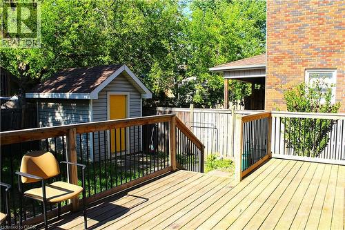 Spacious outdoor deck featuring wood flooring and black metal balusters - 4935 Willmott Street, Niagara Falls, ON 