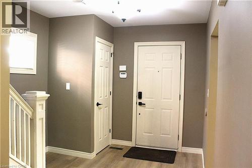 Entry foyer featuring light wood-finish flooring, neutral-toned walls, and white trim - 4935 Willmott Street, Niagara Falls, ON 