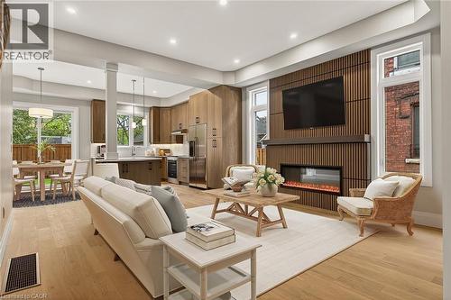 Open-concept living space with light wood-finish flooring - 279 Hess Street S, Hamilton, ON - Indoor Photo Showing Living Room With Fireplace