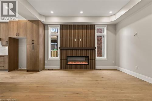 Open-concept living space with light wood-finish flooring - 279 Hess Street S, Hamilton, ON - Indoor With Fireplace