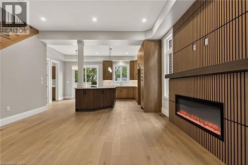 Open-concept living space with light wood-finish flooring - 279 Hess Street S, Hamilton, ON - Indoor With Fireplace