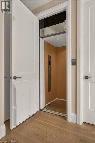 Private residential elevator with wood-finish flooring and recessed lighting - 279 Hess Street S, Hamilton, ON - Indoor Photo Showing Other Room