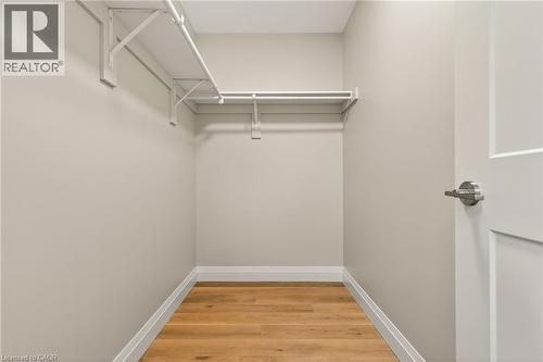 Walk-in closet featuring light wood-finish flooring, white baseboards, and neutral wall paint - 279 Hess Street S, Hamilton, ON - Indoor With Storage