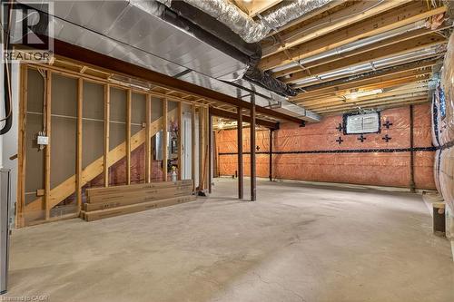 Unfinished basement featuring concrete flooring, exposed wood joists, and visible insulation along the perimeter walls - 279 Hess Street S, Hamilton, ON - Indoor Photo Showing Basement