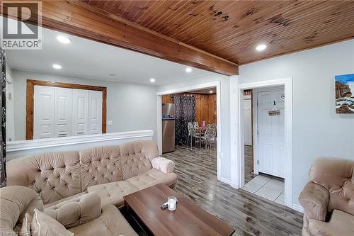Living area featuring a wood-finish plank ceiling with exposed beams, recessed lighting, and wood-finish flooring - 463 Wellington Street N, Hamilton, ON - Indoor