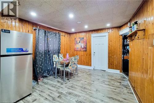 Room featuring wood-paneled walls, wood-finish flooring, and recessed lighting - 463 Wellington Street N, Hamilton, ON - Indoor