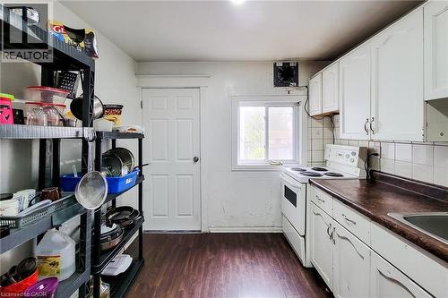 Kitchen featuring wood-finish flooring and white cabinetry - 463 Wellington Street N, Hamilton, ON - Indoor Photo Showing Kitchen