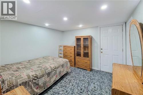 White paneled door with brass hardware, light-toned walls, recessed lighting, and patterned low-pile carpeting - 463 Wellington Street N, Hamilton, ON - Indoor Photo Showing Bedroom