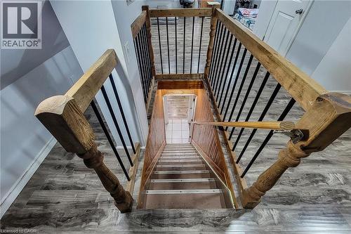 Staircase featuring wood newel posts, wood handrails, and black metal balusters - 463 Wellington Street N, Hamilton, ON - Indoor Photo Showing Other Room