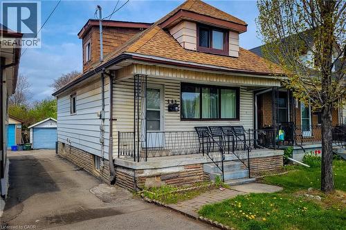 Front elevation featuring light-colored horizontal siding and a dormer with shingle siding - 463 Wellington Street N, Hamilton, ON - Outdoor With Deck Patio Veranda