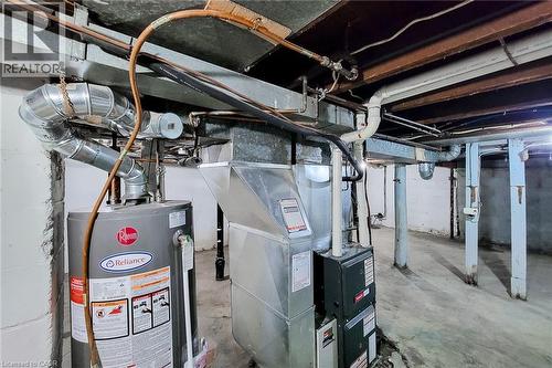 Mechanical room featuring a water heater, furnace, and exposed ductwork - 463 Wellington Street N, Hamilton, ON - Indoor Photo Showing Basement