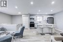 Open-concept living space featuring a modern kitchen with a large island, stainless steel appliances, white cabinetry, and recessed lighting - 2367 Middlesmoor Crescent, Burlington, ON  - Indoor 