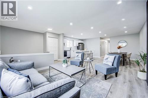 Open-concept living space featuring recessed lighting, light-tone wood-finish flooring, and light gray wall tones - 2367 Middlesmoor Crescent, Burlington, ON - Indoor Photo Showing Living Room
