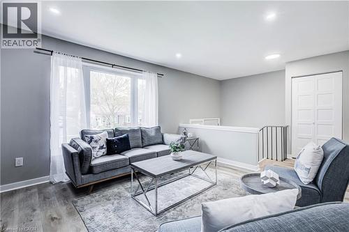 Open-concept living space featuring wood-finish flooring, recessed lighting, and a large window with ample natural light - 2367 Middlesmoor Crescent, Burlington, ON - Indoor Photo Showing Living Room