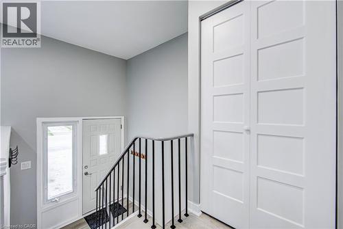 Entryway featuring a paneled front door with frosted glass insert, an adjacent sidelight, and light wood-finish flooring - 2367 Middlesmoor Crescent, Burlington, ON - Indoor Photo Showing Other Room
