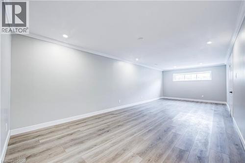 Spacious interior room featuring light-toned wood-finish flooring, recessed lighting, and crown molding - 2367 Middlesmoor Crescent, Burlington, ON - Indoor Photo Showing Other Room