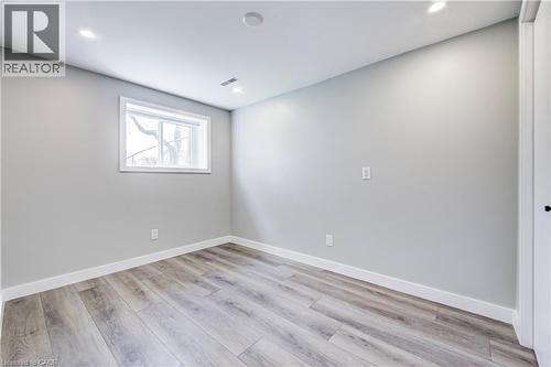 Room featuring wood-finish flooring, recessed lighting, and a white-framed window - 2367 Middlesmoor Crescent, Burlington, ON - Indoor Photo Showing Other Room