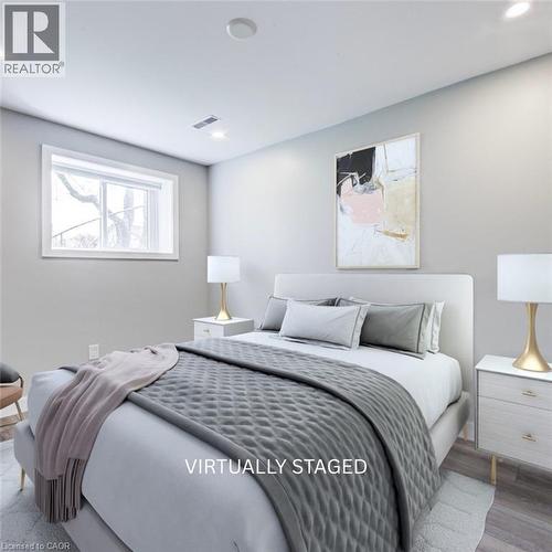Bedroom featuring light gray walls, a window with white trim, recessed ceiling lighting, and light wood-finish flooring - 2367 Middlesmoor Crescent, Burlington, ON - Indoor Photo Showing Bedroom