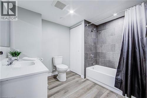 Bathroom featuring a white vanity with an integrated sink, chrome faucet, and mirrored cabinet - 2367 Middlesmoor Crescent, Burlington, ON - Indoor Photo Showing Bathroom