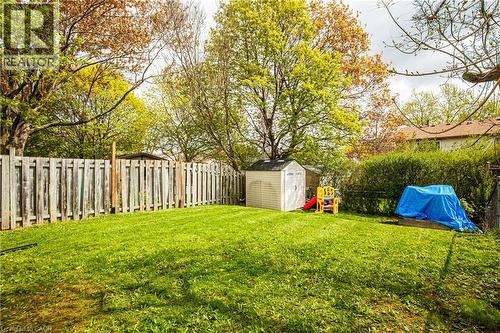 Spacious backyard featuring a manicured lawn, a privacy fence, mature trees, and a storage shed - 2367 Middlesmoor Crescent, Burlington, ON - Outdoor