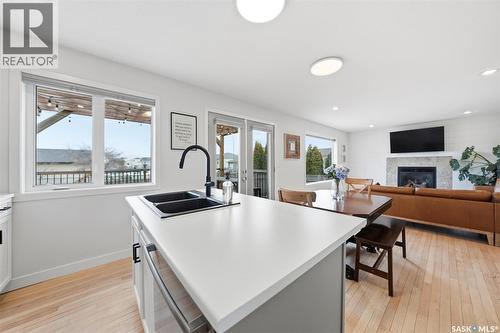 402 Crystal Bay, Warman, SK - Indoor Photo Showing Kitchen With Fireplace With Double Sink