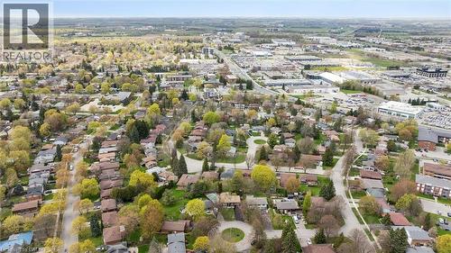 Aerial perspective showcasing a residential neighborhood with established trees and detached homes - 176 Woodville Place, Waterloo, ON - Outdoor With View