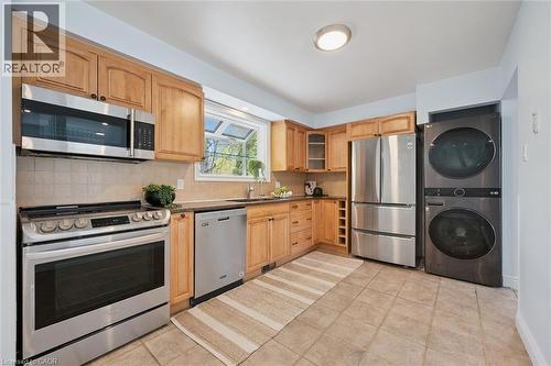 Kitchen featuring light wood cabinetry, stainless steel appliances, and tile flooring - 176 Woodville Place, Waterloo, ON - Indoor Photo Showing Kitchen