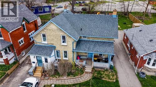 Two-story brick residence featuring a charcoal shingle roof and a covered front porch - 46 Shanley Street, Kitchener, ON - Outdoor With Deck Patio Veranda