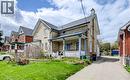 Brick exterior residence featuring a front porch with white railing, a side driveway, and a gabled roofline - 46 Shanley Street, Kitchener, ON  - Outdoor With Deck Patio Veranda With Facade 