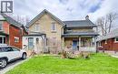 Brick facade residence featuring a front lawn and a covered porch with white railings - 46 Shanley Street, Kitchener, ON  - Outdoor 