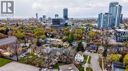 Aerial perspective showcasing a residential neighborhood with varying architectural styles, mature trees, and a visible street grid - 