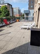 Expansive outdoor terrace featuring paver flooring and a glass and metal railing system - 