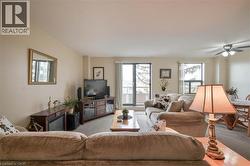 Open concept living area with light-colored walls and neutral carpeting - 